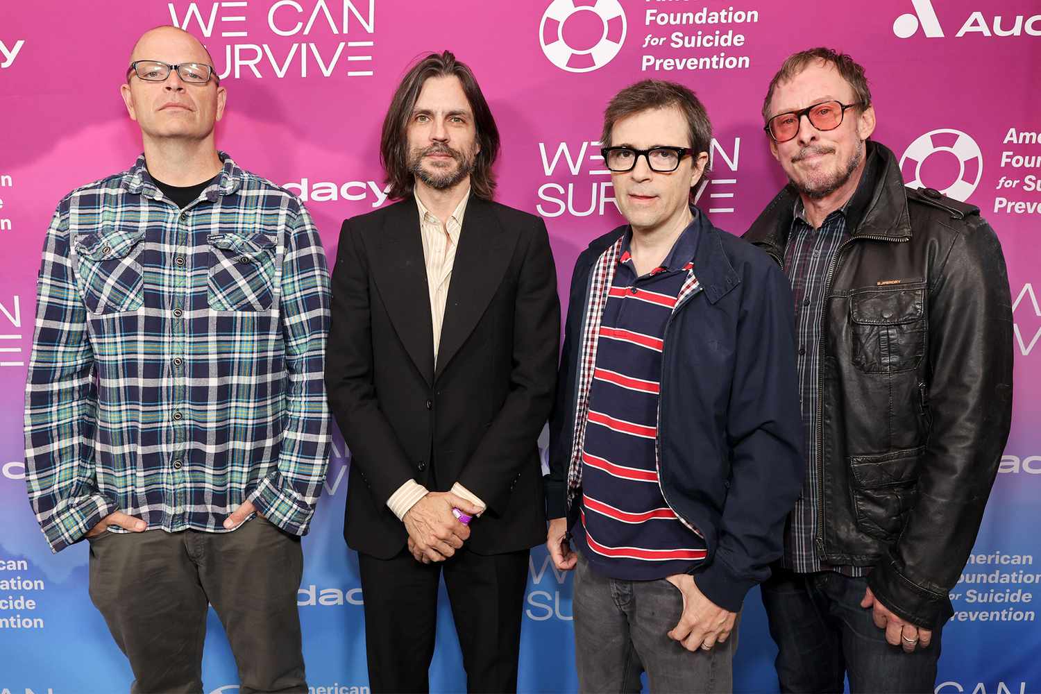 The band members of Weezer, Patrick Wilson, Brian Bell, Rivers Cuomo, and Scott Shriner, left to right, standing in front of Paramount.